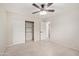 Bedroom featuring tile floor, ceiling fan, neutral paint, and closet with built-in shelving at 302 W Thunderbird Rd, Phoenix, AZ 85023