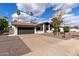 Exterior view of the house showcasing the garage, landscaping, walkway and front yard at 302 W Thunderbird Rd, Phoenix, AZ 85023