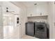 Laundry room with washer/dryer, built-in cabinets, and view to bright open room at 302 W Thunderbird Rd, Phoenix, AZ 85023