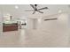 Open-concept living room with tile floors, ceiling fan, and a clear view into the kitchen at 302 W Thunderbird Rd, Phoenix, AZ 85023