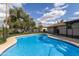 A large, sparkling pool with a safety fence, offers backyard fun and relaxation at 302 W Thunderbird Rd, Phoenix, AZ 85023