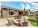 Outdoor patio featuring dining furniture, a fire pit, and green turf at 3123 E Cat Balue Dr, Phoenix, AZ 85050