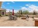 Backyard patio with dining furniture, a fire pit, and outdoor grill at 3123 E Cat Balue Dr, Phoenix, AZ 85050