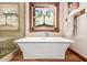 Beautiful bathroom featuring a standalone tub, a stained glass window, and a glass enclosed shower at 3123 E Cat Balue Dr, Phoenix, AZ 85050