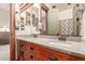 Bathroom featuring double vanity, decorative faucets, granite countertop, and wood cabinetry at 3123 E Cat Balue Dr, Phoenix, AZ 85050