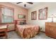 Cozy bedroom featuring unique trim work, a ceiling fan, and warm, neutral paint at 3123 E Cat Balue Dr, Phoenix, AZ 85050