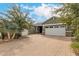 Spacious home featuring a three-car garage, desert landscaping, and paver driveway at 3123 E Cat Balue Dr, Phoenix, AZ 85050