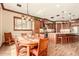 Open kitchen and dining area featuring custom wood cabinets, stone countertops, and stainless steel appliances at 3123 E Cat Balue Dr, Phoenix, AZ 85050