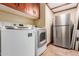 Bright laundry room with modern washer, dryer, and stainless-steel refrigerator at 3123 E Cat Balue Dr, Phoenix, AZ 85050