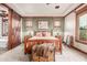 Relaxing bedroom with custom trim, neutral tones, a ceiling fan, and an ensuite bathroom at 3123 E Cat Balue Dr, Phoenix, AZ 85050