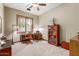 Home office with wood trim, natural light from large window, and wood desk and bookshelf at 3123 E Cat Balue Dr, Phoenix, AZ 85050