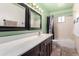 Well-lit bathroom features a vanity with double sinks and a shower-tub combination at 323 N Hunt E Dr, Mesa, AZ 85203