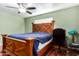 Bedroom includes hardwood floors, a ceiling fan, and a wooden bed frame at 323 N Hunt E Dr, Mesa, AZ 85203