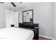 Bedroom with hardwood floors, ceiling fan, gray walls, and black furniture at 323 N Hunt E Dr, Mesa, AZ 85203