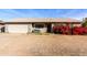 Charming single-story home featuring an attached garage and a beautiful red bougainvillea bush at 323 N Hunt E Dr, Mesa, AZ 85203