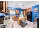 Kitchen with wood cabinets, granite countertops, and blue walls at 323 N Hunt E Dr, Mesa, AZ 85203