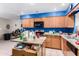 A kitchen featuring wood cabinets, an island, and an open layout at 323 N Hunt E Dr, Mesa, AZ 85203