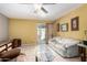 Living room with a slider to backyard, couch, and ceiling fan at 323 N Hunt E Dr, Mesa, AZ 85203