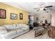 Cozy living room featuring a ceiling fan, tile floors, and ample natural light at 323 N Hunt E Dr, Mesa, AZ 85203