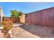 Backyard featuring landscaping with stone pathway to building and wood fence at 3324 W Tangerine Ln, Phoenix, AZ 85051