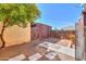 Landscaped backyard with stone pavers and a small tree, creating a serene outdoor space at 3324 W Tangerine Ln, Phoenix, AZ 85051