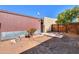 Backyard featuring landscaping with stone pathway to building and wood fence at 3324 W Tangerine Ln, Phoenix, AZ 85051