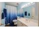 Bathroom featuring a white vanity and mirror with decorative blue accents at 3324 W Tangerine Ln, Phoenix, AZ 85051