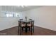 Dining area with hardwood floors and a modern dark wood table with seating for four at 3324 W Tangerine Ln, Phoenix, AZ 85051