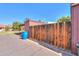 Home exterior featuring a wooden fence and trash container in a well-maintained neighborhood at 3324 W Tangerine Ln, Phoenix, AZ 85051