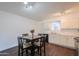 Kitchen and dining area featuring hardwood floors, stainless appliances, and a modern table set at 3324 W Tangerine Ln, Phoenix, AZ 85051