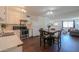 Bright kitchen with white cabinets and stainless steel appliances adjacent to the living area at 3324 W Tangerine Ln, Phoenix, AZ 85051