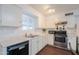 Clean kitchen featuring white cabinets, stainless steel appliances, and hardwood floors at 3324 W Tangerine Ln, Phoenix, AZ 85051