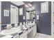 Well-lit bathroom featuring a double vanity, a mirror, and modern fixtures at 3632 E Comstock Dr, Gilbert, AZ 85296