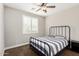 Comfortable bedroom with a black metal bed, window with shutters, and a ceiling fan at 3632 E Comstock Dr, Gilbert, AZ 85296