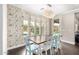 Chic dining area with floral wallpaper, wood floors, and a modern chandelier at 3632 E Comstock Dr, Gilbert, AZ 85296