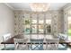 Charming dining room featuring designer wallpaper and a view of the backyard pool at 3632 E Comstock Dr, Gilbert, AZ 85296