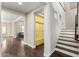 Hallway with wood flooring and a view of staircase and colorful storage space at 3632 E Comstock Dr, Gilbert, AZ 85296