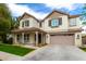 Lovely two-story home featuring a covered porch and an attached two-car garage at 3632 E Comstock Dr, Gilbert, AZ 85296