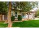 Serene exterior view featuring lush greenery and a charming covered porch with a swing at 3632 E Comstock Dr, Gilbert, AZ 85296