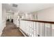 Second floor hallway with dark wood railings and white molding at 3632 E Comstock Dr, Gilbert, AZ 85296