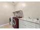 A laundry room with a washing machine, dryer, and sink at 3632 E Comstock Dr, Gilbert, AZ 85296