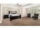 Inviting main bedroom with tray ceilings, neutral walls, carpet floors, and natural light at 3632 E Comstock Dr, Gilbert, AZ 85296