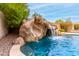 Pool features a stone slide and waterfall feature for endless Gathering fun and relaxation at 3632 E Comstock Dr, Gilbert, AZ 85296