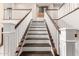 Elegant staircase with dark wood steps and white railings provides a stylish transition at 3632 E Comstock Dr, Gilbert, AZ 85296