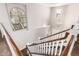 Staircase with a decorative railing and chandelier, illuminated by natural light from nearby window at 3632 E Comstock Dr, Gilbert, AZ 85296