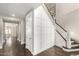 Hallway featuring hardwood floors and a staircase with decorative wainscoting on the wall at 3632 E Comstock Dr, Gilbert, AZ 85296