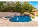 Sparkling pool features a rock waterfall, slide, and spa, creating a backyard oasis at 3632 E Comstock Dr, Gilbert, AZ 85296