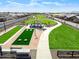 Aerial view of the community amenity features a bocce ball court, covered seating, and a landscaped pathway at 36520 W Maddaloni Ave, Maricopa, AZ 85138