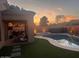 Relaxing backyard with a pool, hot tub, and outdoor seating area at sunset at 3904 E Carter Dr, Phoenix, AZ 85042