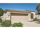 Beige two-car garage of a single-story home featuring desert landscaping and a tile roof at 3904 E Carter Dr, Phoenix, AZ 85042